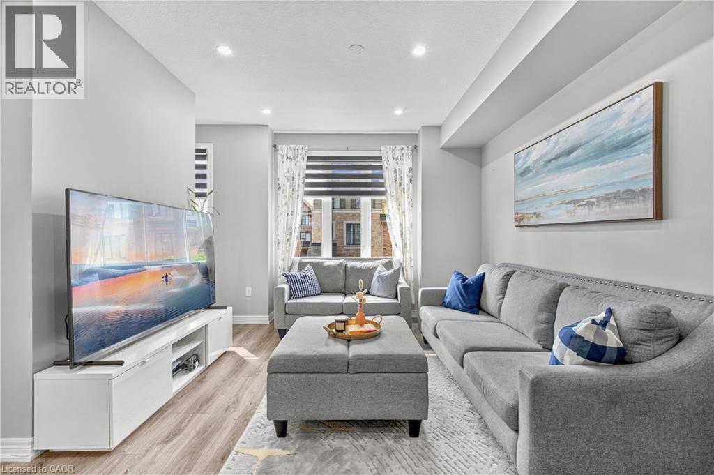 Recessed ceiling lighting, wood-finish flooring, and light gray wall paint - 1890 Rymal Road E Unit# 144, Hamilton, ON