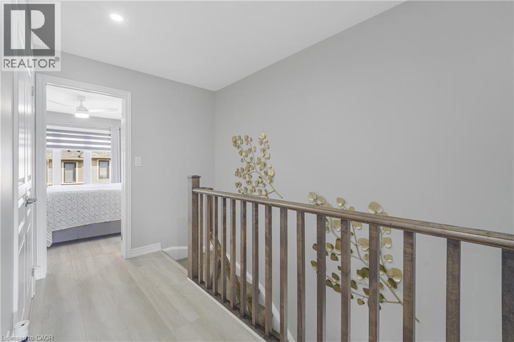 Wood-finish flooring throughout the hallway - 1890 Rymal Road E Unit# 144, Hamilton, ON