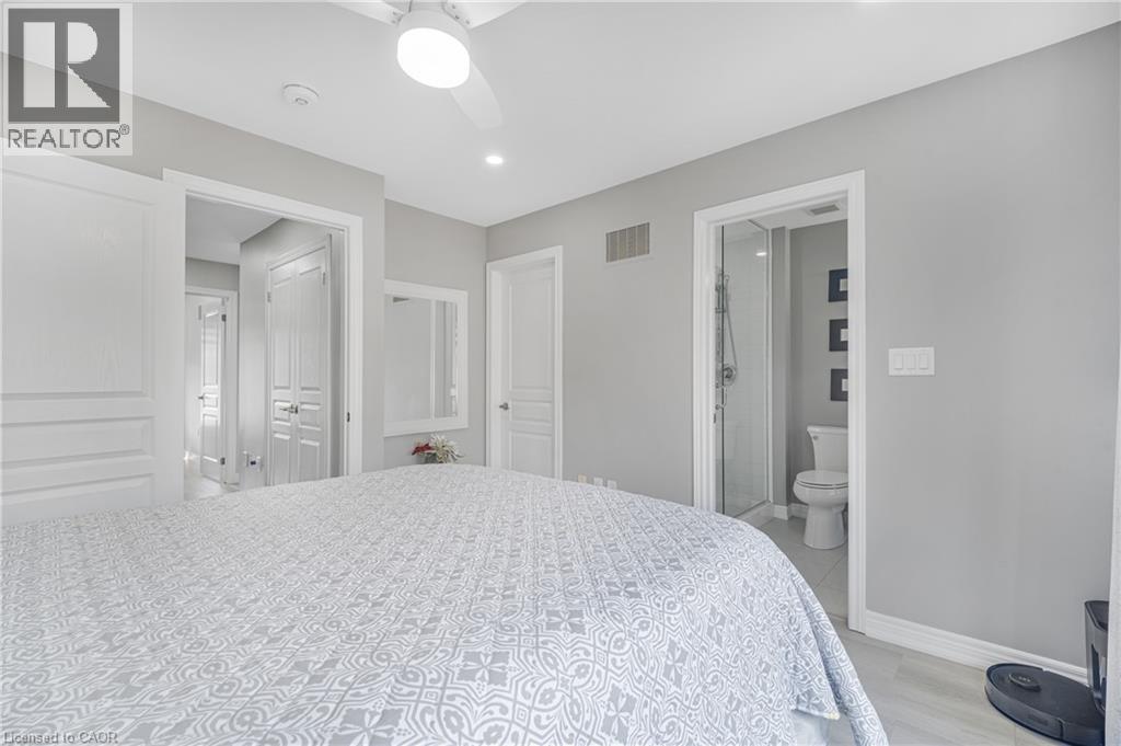 Recessed lighting, ceiling fan, wood-finish flooring, white trim, and a full bathroom with a walk-in shower - 1890 Rymal Road E Unit# 144, Hamilton, ON