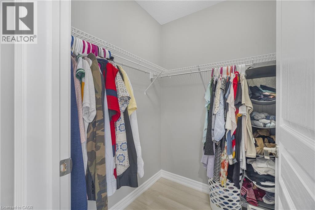 Walk-in closet featuring light gray walls, wire shelving, and wood-finish flooring - 1890 Rymal Road E Unit# 144, Hamilton, ON