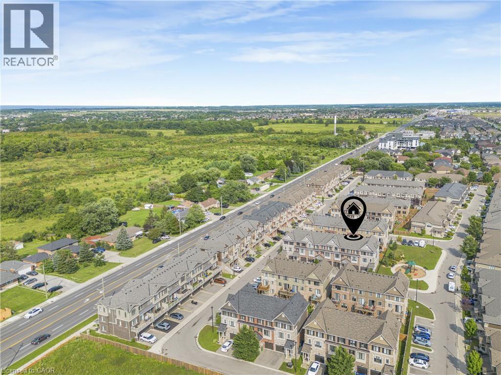 Aerial perspective showcasing a residential community with townhomes and detached properties - 1890 Rymal Road E Unit# 144, Hamilton, ON