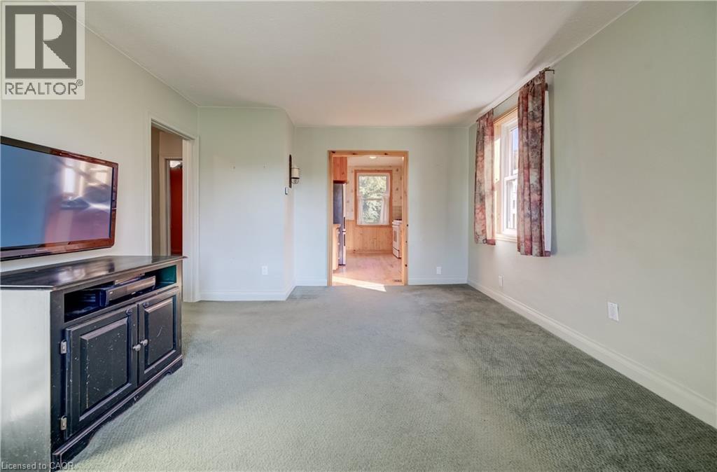Carpeted flooring throughout, light-toned walls, and a window with curtains - 174 Bridgeport Road E, Waterloo, ON