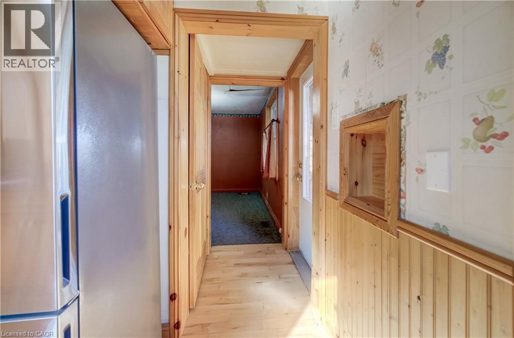Wood-finish flooring with coordinating wood trim and wainscoting - 174 Bridgeport Road E, Waterloo, ON