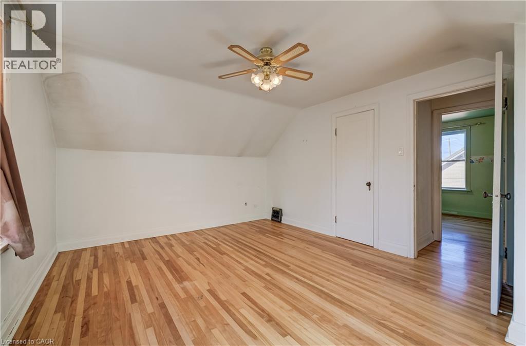 Hardwood flooring, sloped ceiling, ceiling fan with light fixture, interior - 174 Bridgeport Road E, Waterloo, ON