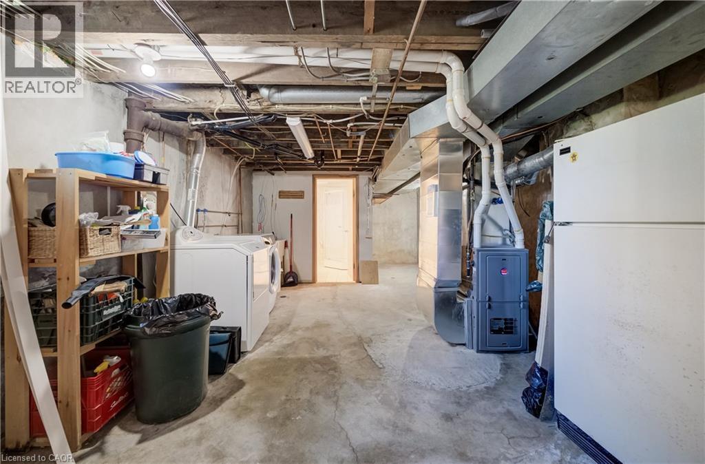 Concrete flooring with exposed ceiling joists, laundry and utility room - 174 Bridgeport Road E, Waterloo, ON