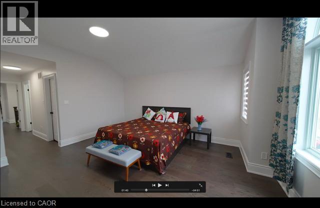 Wood-finish flooring, recessed lighting, window with plantation shutters, and a prominent doorway - 643 Doon South Drive, Kitchener, ON