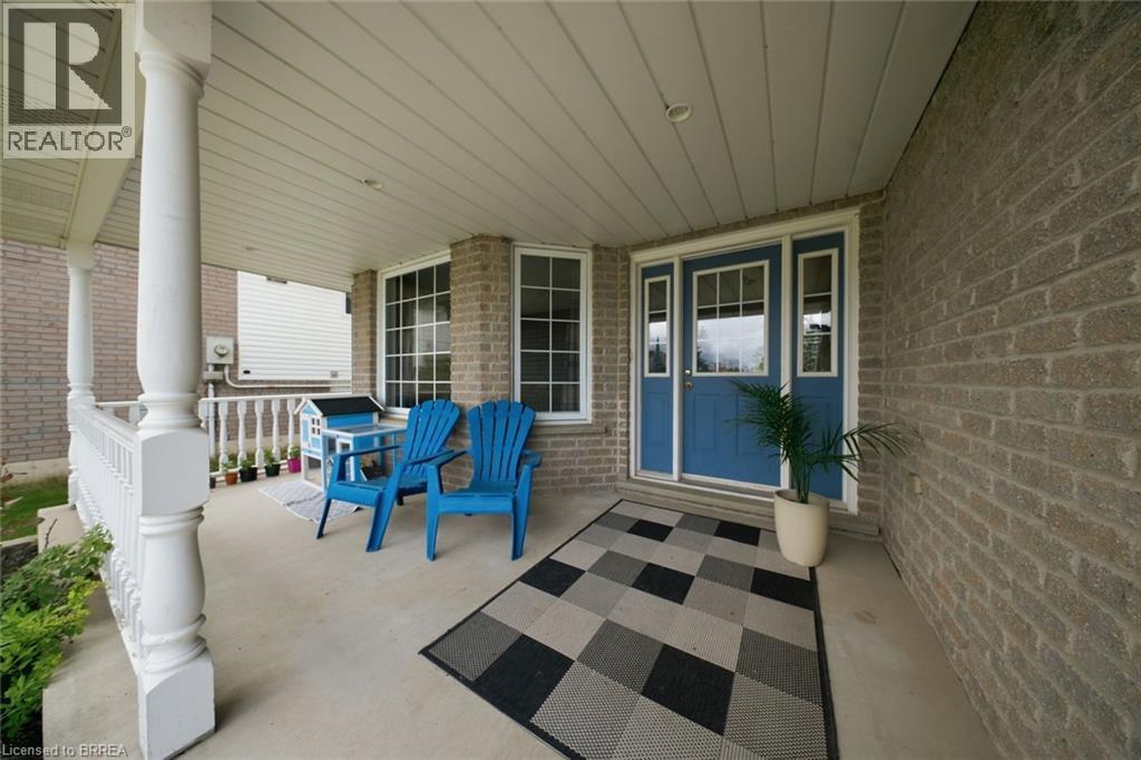 Covered front porch featuring brick exterior - 61 Sunnyside Drive, St. George, ON