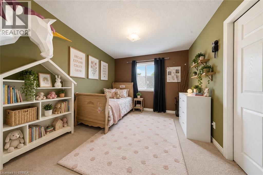 Built-in shelving unit with multiple compartments, wall-mounted floating shelves, and window with dark drapery - 61 Sunnyside Drive, St. George, ON