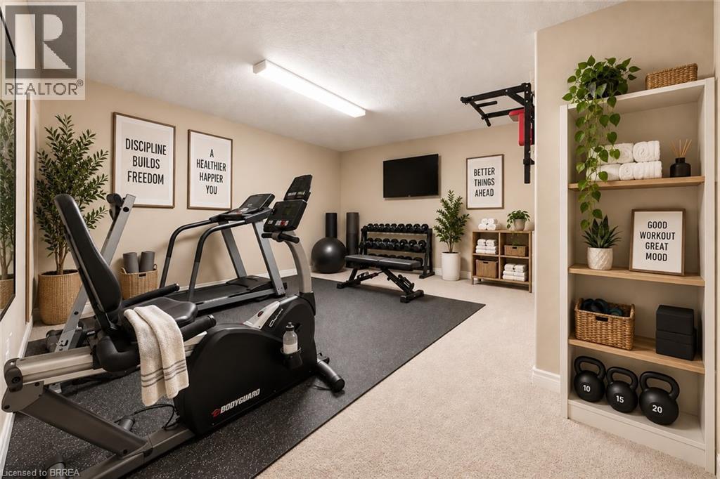 Dedicated fitness space featuring wall-mounted shelving, built-in storage, and wall-mounted television - 61 Sunnyside Drive, St. George, ON