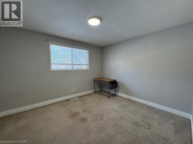 Recessed lighting fixture, light gray wall paint, window with white trim, light-colored carpeting - 511 Havelock Drive, Waterloo, ON