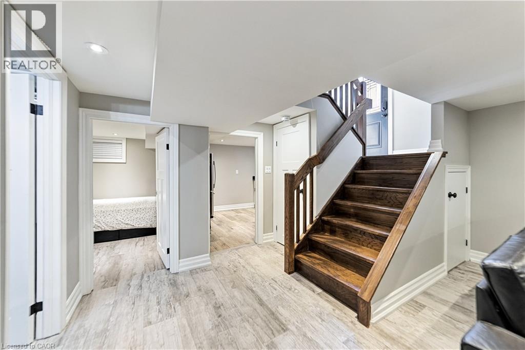 Wood like finish ceramic flooring in basement, extra storage space under staircase. - 58 Uplands Avenue, Hamilton, ON