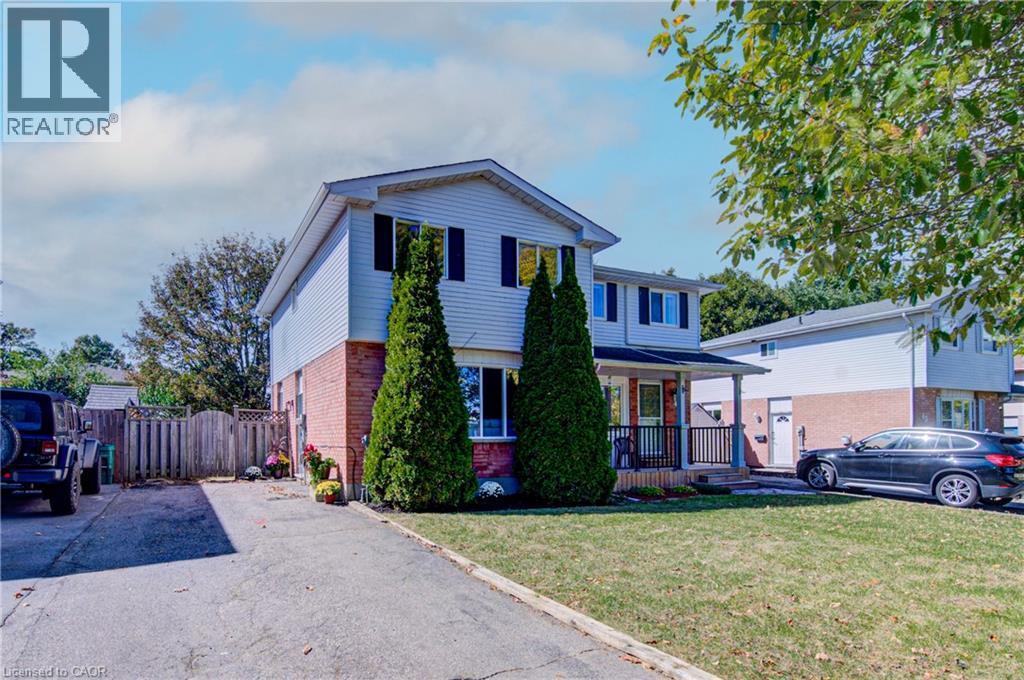 Two-story residence featuring light-toned siding and brick exterior - 39 Connelly Drive, Kitchener, ON