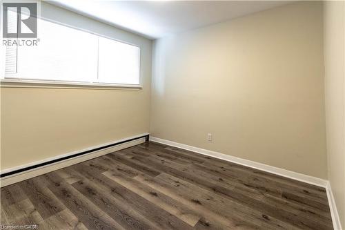 Wood-finish flooring, neutral wall paint, and horizontal window blinds - 499 East 16Th Street, Hamilton, ON 
