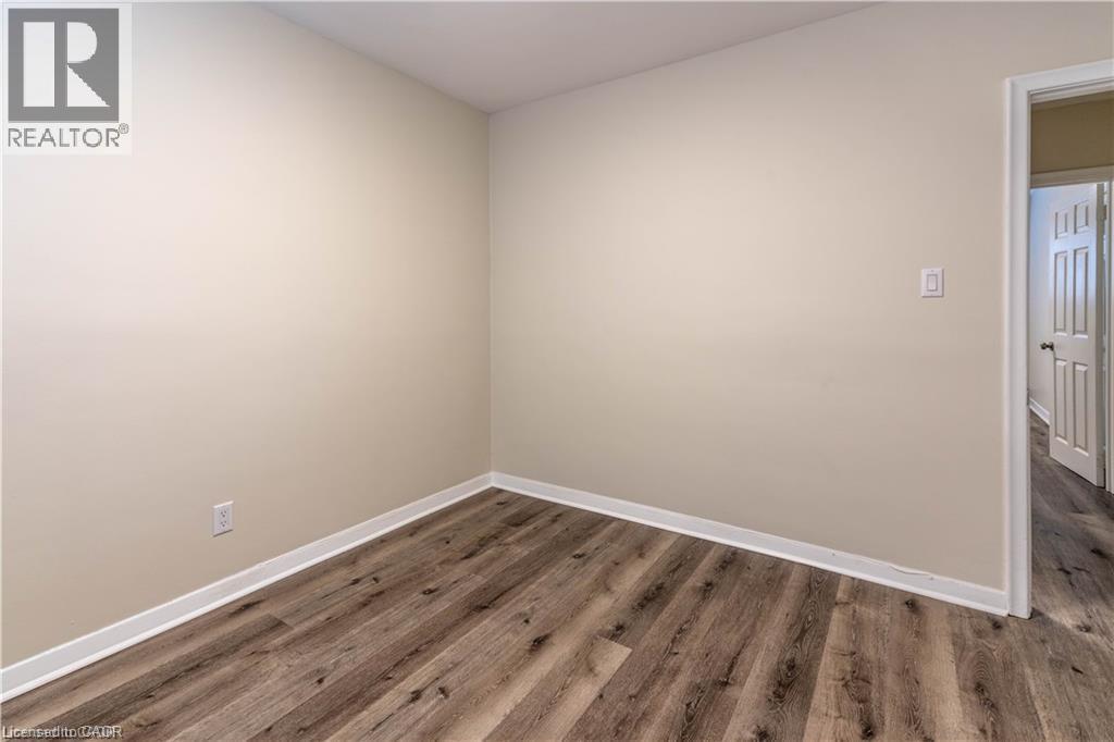 Wood-finish flooring with light-toned walls - 499 East 16Th Street, Hamilton, ON