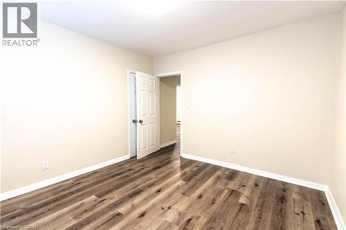 Wood-finish flooring, neutral wall tones, and white trim - 499 East 16Th Street, Hamilton, ON 