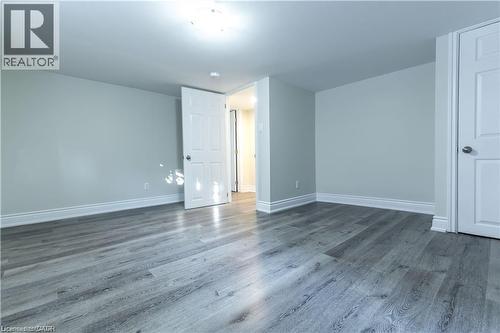 Recessed lighting, wood-finish flooring, white baseboards, and white interior doors - 499 East 16Th Street, Hamilton, ON 
