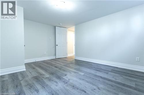 Wood-finish flooring, white trim, recessed lighting, and a white interior door - 499 East 16Th Street, Hamilton, ON 