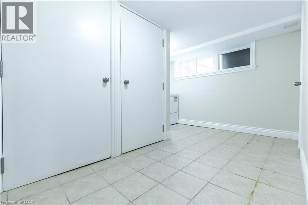 Tile flooring, white walls, and two built-in storage closets - 499 East 16Th Street, Hamilton, ON