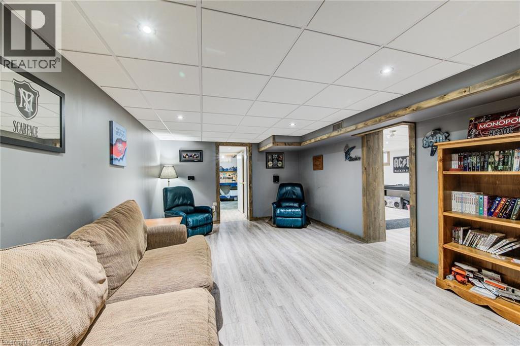 Recessed lighting, wood-finish flooring, drop ceiling, light gray wall paint, and exposed wood trim - 192 Warren Road, Kitchener, ON