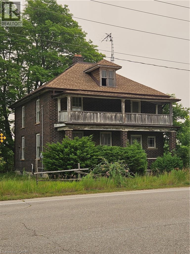 Brick exterior with a shingled gambrel roof and a dormer - 1720 Beaverdale Road, Cambridge, ON