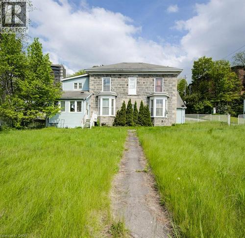 Stone facade residence featuring two bay windows and a central pathway - 245 Ainslie Street S, Cambridge, ON 