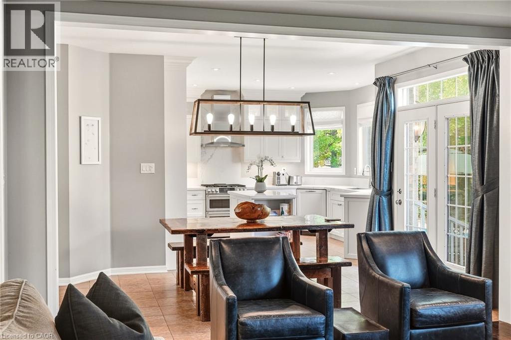 Recessed lighting, wood-finish flooring, white cabinetry, stainless steel appliances, and French doors - 536 Cusick Circle, Milton, ON