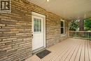 Stone veneer exterior detailing, covered porch with recessed lighting, wood-finish flooring, and a decorative wood railing - 275 Main Street, Cambridge, ON 