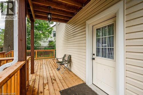 Wood deck with wood railings, suspended ceiling light, and panel siding exterior - 275 Main Street, Cambridge, ON 