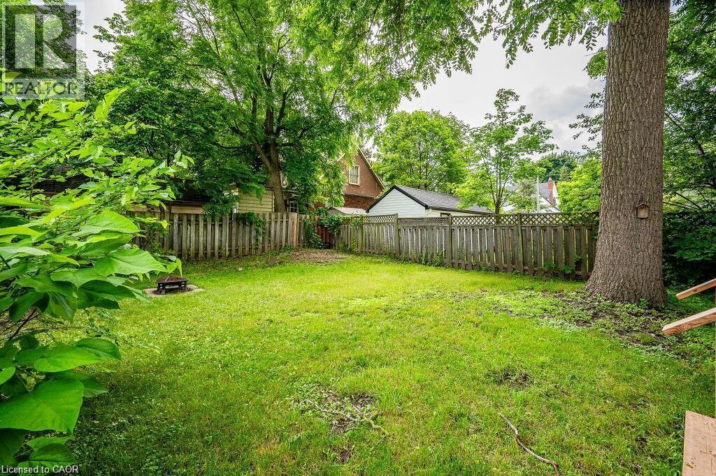 Expansive grassy yard with mature trees and wood fencing - 275 Main Street, Cambridge, ON