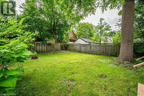 Expansive grassy yard with mature trees and wood fencing - 275 Main Street, Cambridge, ON 