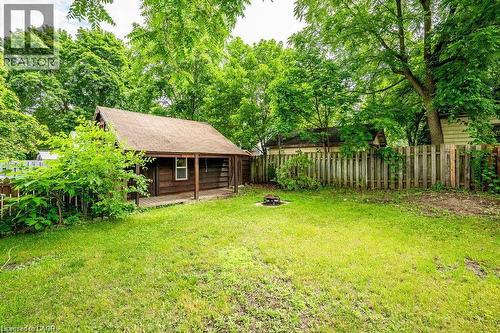 Expansive lawn area with a wood privacy fence and mature trees - 275 Main Street, Cambridge, ON 