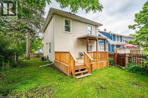 Rear exterior with horizontal siding, wooden deck, wooden steps, covered porch, and a fenced yard - 275 Main Street, Cambridge, ON 