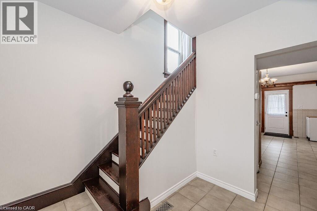Staircase with wood-finish newel post and balusters - 275 Main Street, Cambridge, ON