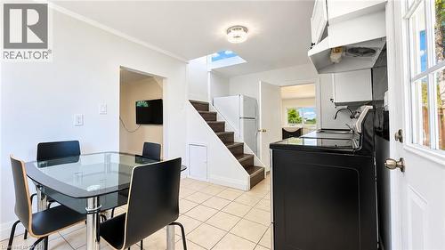 Kitchen area with tile flooring, white cabinetry, and white ceiling fan light fixture - 76 Avenue Road, Cambridge, ON 