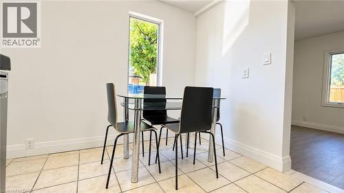 Light-toned tile flooring, tall casement window, and crisp white walls - 76 Avenue Road, Cambridge, ON 