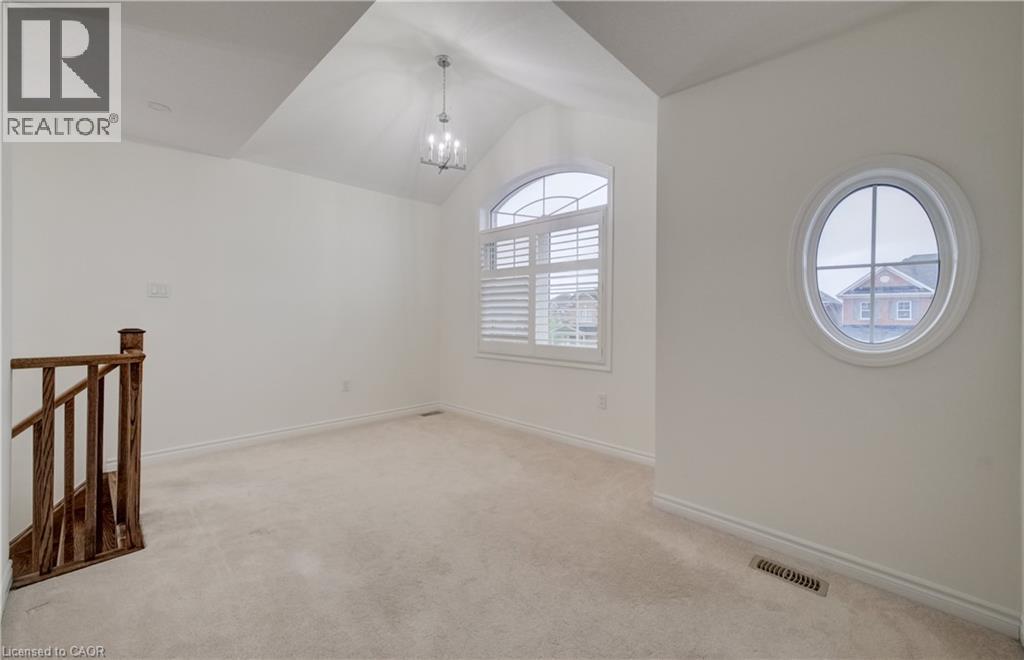 Extended vanity with integrated sink, white cabinetry, and large mirror with overhead lighting - 52 Pointer Street, Cambridge, ON