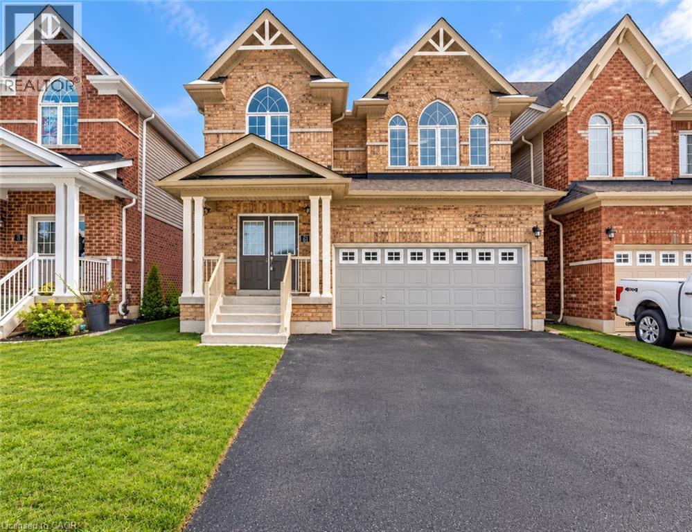 Brick exterior featuring twin gables and arched windows - 61 Duckworth Road, Cambridge, ON