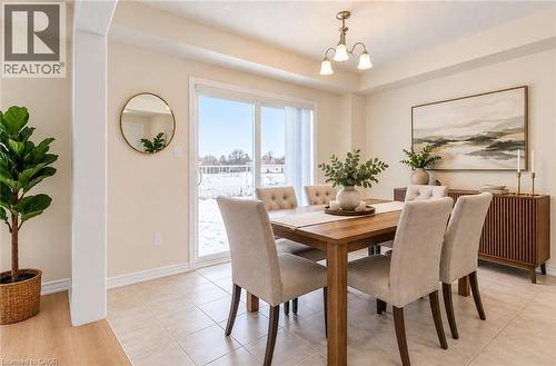 Light-toned tile flooring, white trim, and a sliding glass door - 61 Duckworth Road, Cambridge, ON 