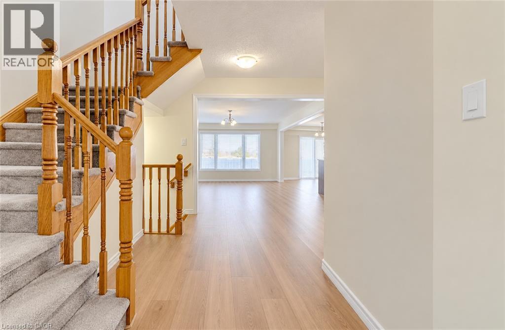 Wood-finish flooring throughout the main level - 61 Duckworth Road, Cambridge, ON