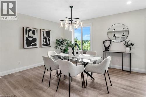 Wood-finish flooring, white walls, and a large window - 46 Esther Avenue, Cambridge, ON 