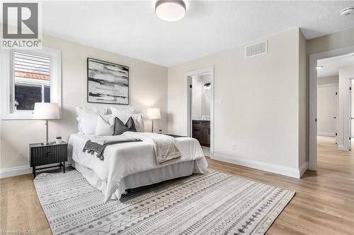 Light-toned wood-finish flooring complements neutral wall tones - 46 Esther Avenue, Cambridge, ON 