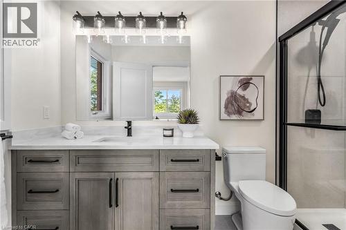 Modern vanity with a light wood-finish, featuring a white countertop and rectangular undermount sink - 46 Esther Avenue, Cambridge, ON 