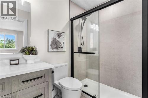 Vanity with stone countertop, wood-finish cabinetry, and matte black hardware - 46 Esther Avenue, Cambridge, ON 