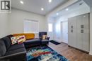 Recessed ceiling lighting, wood-finish flooring, white walls, built-in storage cabinetry with matte black hardware, and a white window with blinds - 78 Hillyard Street, Hamilton, ON 