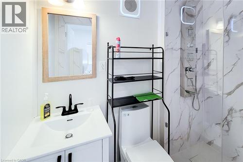 Vanity with white integrated sink and matte black faucet - 78 Hillyard Street, Hamilton, ON 