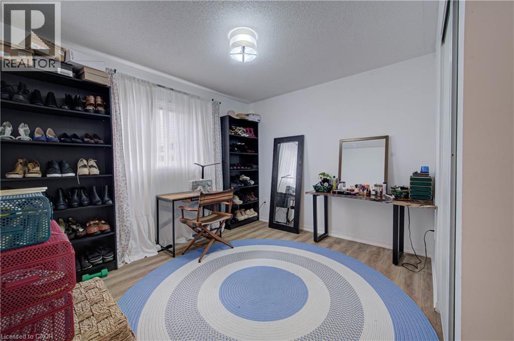 Recessed window with sheer white curtains, wood-finish flooring, and a flush mount ceiling light - 317 Christopher Drive, Cambridge, ON