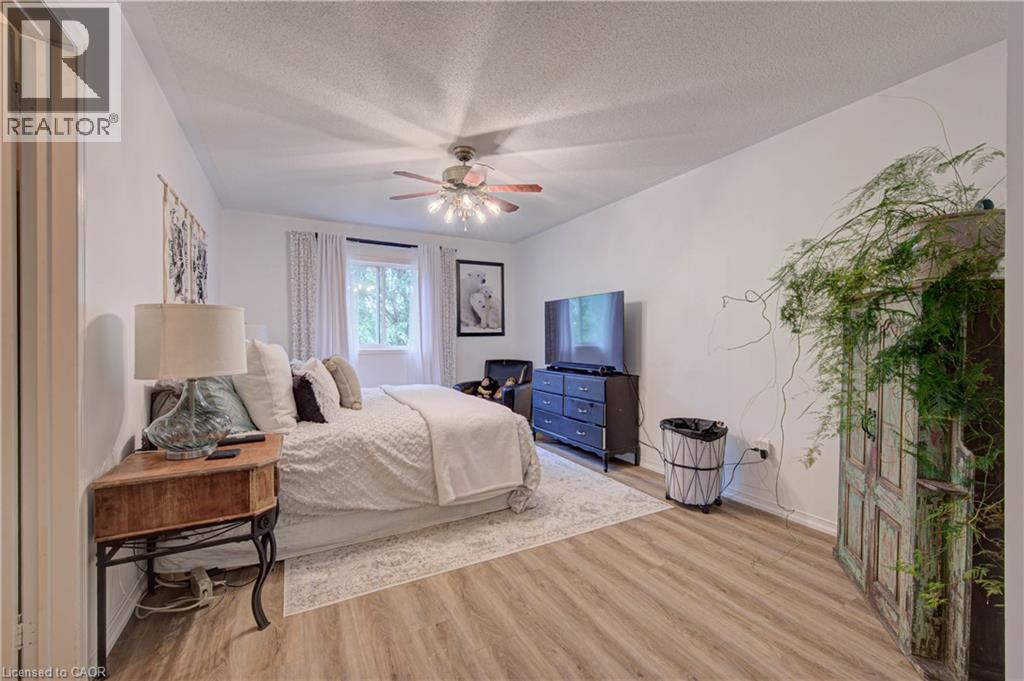 Wood-finish flooring with white walls and a ceiling fan - 317 Christopher Drive, Cambridge, ON