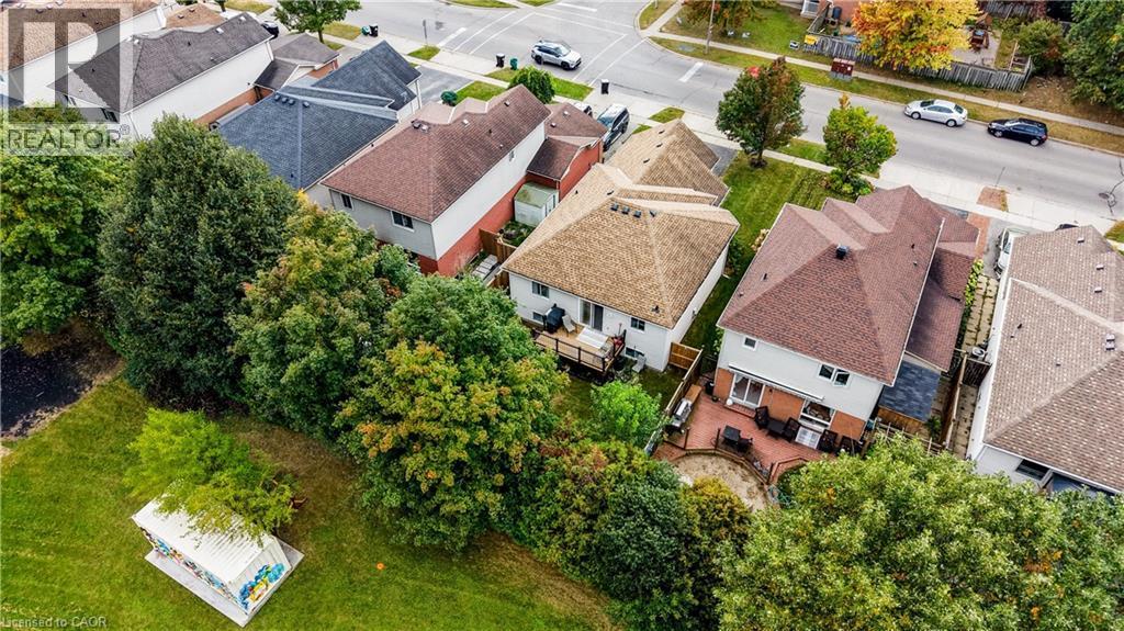 Two-story residence with a brown shingled roof and light-colored siding - 317 Christopher Drive, Cambridge, ON