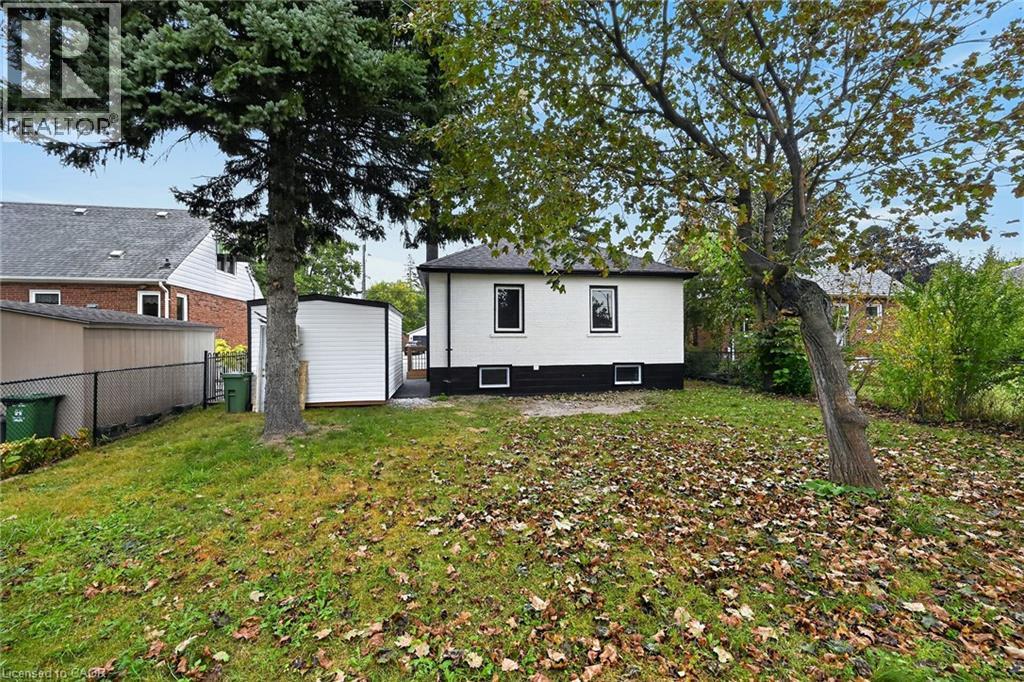 Expansive yard space with mature trees and a detached shed - 50 West 4Th Street, Hamilton, ON