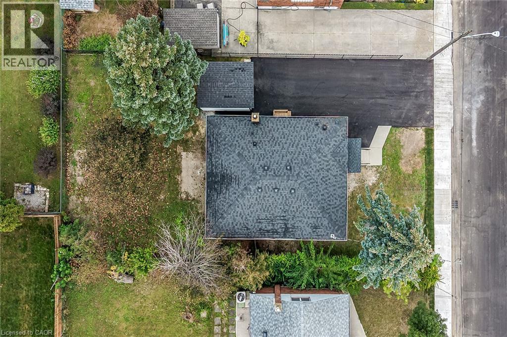 Asphalt shingle roof, paved driveway, concrete walkway, mature trees - 50 West 4Th Street, Hamilton, ON